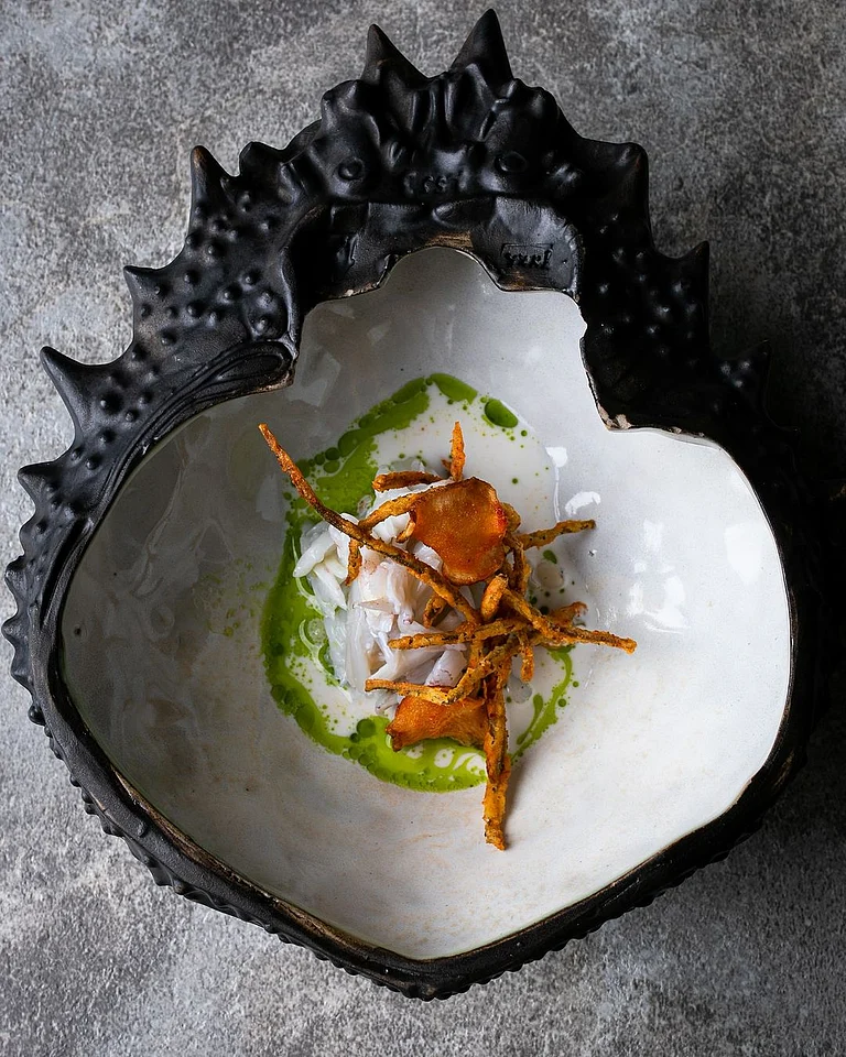 Blue Swimmer Crab served with coconut milk spiked with grilled banana leaves at Gaa - Gaa